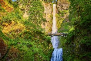 People on a bridge overlooking one of the Columbia River Gorge waterfalls.