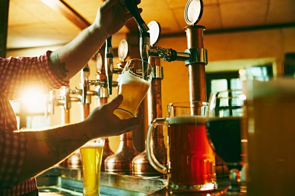 A person pouring a beer at one of the breweries near Hood River, Oregon.